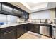 Well-lit kitchen offering dark wood cabinets, stainless steel appliances, and ample counter space at 2673 Red Rock St # 102, Las Vegas, NV 89146
