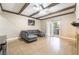 Spacious living room with tile floors, ceiling fan, exposed beams, and sliding glass door to patio at 2673 Red Rock St # 102, Las Vegas, NV 89146