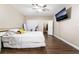 Bedroom with a TV, wood floors, ceiling fan and walk in closet at 2673 Red Rock St # 102, Las Vegas, NV 89146