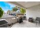 Private patio with BBQ grill and outdoor seating, perfect for relaxing or entertaining at 2673 Red Rock St # 102, Las Vegas, NV 89146