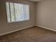 Bright bedroom featuring a large window with blinds and neutral carpeting at 2900 Sunridge Heights Pkwy # 327, Henderson, NV 89052