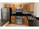 Well-lit kitchen showcasing stainless steel appliances, dark counters, and light wood cabinetry at 2900 Sunridge Heights Pkwy # 327, Henderson, NV 89052