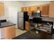 Bright kitchen featuring stainless appliances, dark countertops, and light wood cabinets, perfect for cooking at 2900 Sunridge Heights Pkwy # 327, Henderson, NV 89052