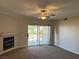 Carpeted living room with fan, fireplace and sliding doors to patio, offering bright and airy space at 2900 Sunridge Heights Pkwy # 327, Henderson, NV 89052