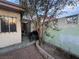 Backyard featuring a brick-lined garden bed and covered patio area at 3946 Voxna St, Las Vegas, NV 89119