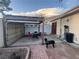 The fenced in backyard features a large carport and patio area with table and chairs at 3946 Voxna St, Las Vegas, NV 89119
