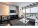 Open concept living area with sleek furniture, floor-to-ceiling windows with a great view, and a modern entertainment center at 4381 W Flamingo Rd # 2405, Las Vegas, NV 89103