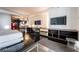 Modern living room with sleek furniture, built-in shelves, mounted TVs and a glimpse of the kitchen area at 4381 W Flamingo Rd # 2405, Las Vegas, NV 89103