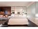 Cozy main bedroom showcasing a plush bed, mirrored wall, and elegant nightstands with lamps at 4381 W Flamingo Rd # 2405, Las Vegas, NV 89103