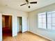 Comfortable bedroom with hardwood floors, a ceiling fan, closet and window, providing a relaxing and functional space at 4520 Lemon Gems Ct, Las Vegas, NV 89130