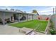 Wide backyard featuring a covered patio, an outdoor grill, and a fire pit with chairs at 4937 Elaina Ave, Las Vegas, NV 89120