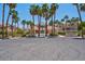 Laguna Del Rey clubhouse surrounded by swaying palms, desert flora and other community buildings at 5000 Red Rock St # 241, Las Vegas, NV 89118