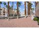 Beautiful community landscaping featuring gravel, tall palms and a canal surrounding the central pool and buildings at 5000 Red Rock St # 241, Las Vegas, NV 89118