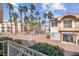Exterior shot of property showcasing well-maintained landscaping, palm trees, and inviting walkways at 5000 Red Rock St # 241, Las Vegas, NV 89118