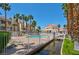 Community pool area with palm trees, lounge seating, and landscaping at 5000 Red Rock St # 241, Las Vegas, NV 89118