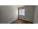 A simply furnished bedroom has tiled floors and a window at 510 Holick Ave, Henderson, NV 89011