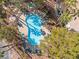 Aerial view of the pool area offers a glimpse of community amenities and surrounding greenery at 5211 Caspian Springs Dr # 201, Las Vegas, NV 89120