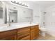 Bathroom features double sinks, wood cabinets, and shower-tub combo at 5211 Caspian Springs Dr # 201, Las Vegas, NV 89120