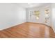 Bedoom features laminate flooring, window with blinds, and access to the patio at 5211 Caspian Springs Dr # 201, Las Vegas, NV 89120