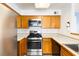 Bright kitchen features stainless steel appliances, wooden cabinetry, and light countertops at 5211 Caspian Springs Dr # 201, Las Vegas, NV 89120