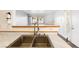 Kitchen sink with tile countertop, new faucet, and pass through window at 5211 Caspian Springs Dr # 201, Las Vegas, NV 89120
