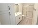Bright bathroom with single sink vanity and sliding glass shower doors at 5222 Mandalay Springs Dr # 202, Las Vegas, NV 89120