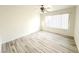 Well-lit bedroom with light wood floors, white walls, and a large window with blinds at 5222 Mandalay Springs Dr # 202, Las Vegas, NV 89120