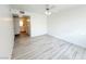 Large bedroom with light wood floors, a ceiling fan, and attached bath access at 5222 Mandalay Springs Dr # 202, Las Vegas, NV 89120