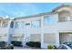 Exterior view of a two-story building with white facade and well-maintained landscaping at 5222 Mandalay Springs Dr # 202, Las Vegas, NV 89120