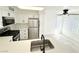 Renovated kitchen includes a stainless steel refrigerator, modern appliances, and island sink at 5222 Mandalay Springs Dr # 202, Las Vegas, NV 89120