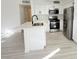 Modern kitchen with stainless steel appliances, white cabinets, and a breakfast bar with a sink at 5222 Mandalay Springs Dr # 202, Las Vegas, NV 89120