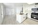 Bright kitchen with white cabinets, stainless steel appliances, and a center island with a sink at 5222 Mandalay Springs Dr # 202, Las Vegas, NV 89120