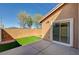 Patio with artificial turf, sliding glass door, and brick wall at 5292 Cholla Cactus Ave, Las Vegas, NV 89141