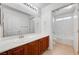 Bathroom featuring a wooden vanity with double sinks and a separate toilet room at 5292 Cholla Cactus Ave, Las Vegas, NV 89141