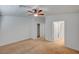 Well-lit bedroom features neutral carpet, ceiling fan, and closet, leading into bathroom at 5292 Cholla Cactus Ave, Las Vegas, NV 89141