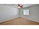 Bright bedroom features neutral carpet, a ceiling fan, and a window with blinds at 5292 Cholla Cactus Ave, Las Vegas, NV 89141