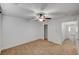 Bedroom features neutral carpet, ceiling fan, and white trim at 5292 Cholla Cactus Ave, Las Vegas, NV 89141