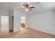 Carpeted bedroom with ceiling fan leads to the ensuite bathroom and closet at 5292 Cholla Cactus Ave, Las Vegas, NV 89141
