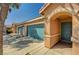 Single Gathering home featuring a charming front entrance, teal garage door, and low maintenance yard at 5292 Cholla Cactus Ave, Las Vegas, NV 89141