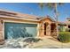 Single Gathering home featuring a charming front entrance, teal garage door, and low maintenance yard at 5292 Cholla Cactus Ave, Las Vegas, NV 89141