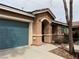 Charming single-story home featuring a teal garage door and low-maintenance desert landscaping at 5292 Cholla Cactus Ave, Las Vegas, NV 89141