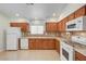Well-lit kitchen featuring wooden cabinets, modern appliances, tile backsplash, and ample counter space at 5292 Cholla Cactus Ave, Las Vegas, NV 89141