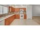 Inviting kitchen featuring wood cabinets, tile backsplash, and modern appliances with natural light at 5292 Cholla Cactus Ave, Las Vegas, NV 89141