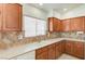 Classic kitchen featuring wood cabinets, tile countertops, stainless steel sink, and modern appliances at 5292 Cholla Cactus Ave, Las Vegas, NV 89141