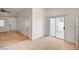 Open-concept living space with tile and carpet flooring, access to a patio, and neutral wall colors at 5292 Cholla Cactus Ave, Las Vegas, NV 89141