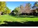 Green lawn and mature trees create a serene landscape around the apartment buildings at 555 E Silverado Ranch Blvd # 2005, Las Vegas, NV 89183