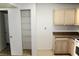 A kitchen with tan cabinets, tile floor, and a pantry with wire shelves at 555 E Silverado Ranch Blvd # 2005, Las Vegas, NV 89183