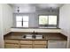 Galley kitchen featuring wood cabinets, laminate counters and a double sink at 555 E Silverado Ranch Blvd # 2005, Las Vegas, NV 89183