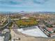 Wide aerial view of a baseball field nestled in a community with desert mountains in the distance under a blue sky at 6 Desert Dawn Ln, Henderson, NV 89074