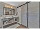 Modern bathroom with a large vanity area, a sliding barn door and hardwood floors at 6 Desert Dawn Ln, Henderson, NV 89074